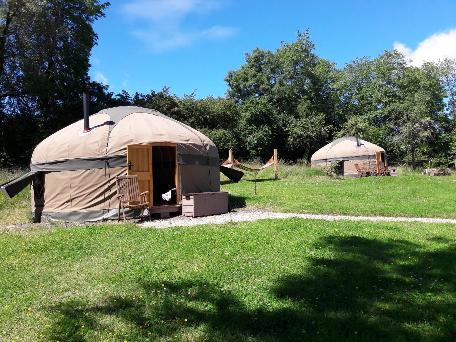 Two yurts with hammocks in between