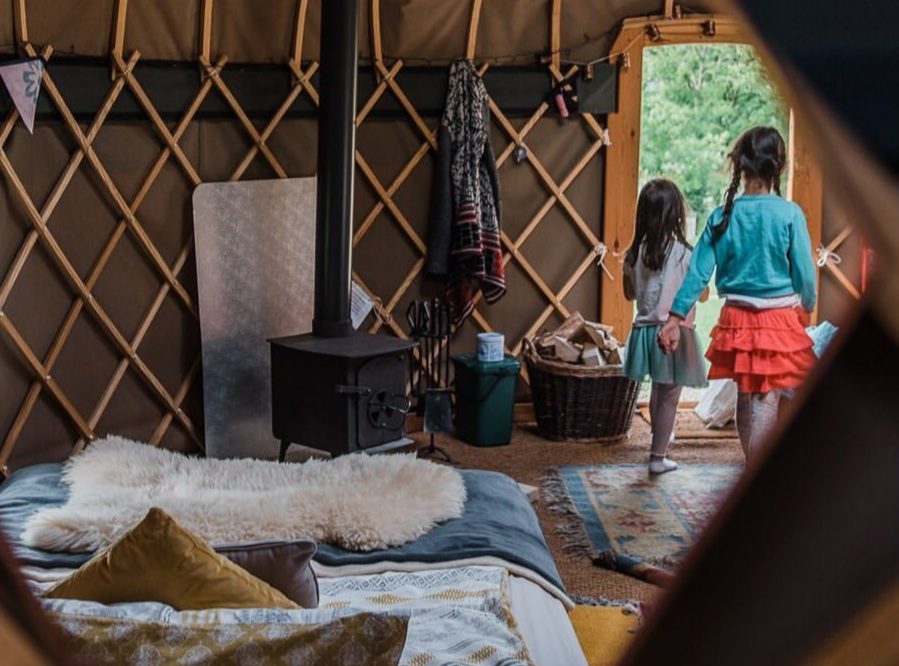 2 young girls standing by doorway of the yurt