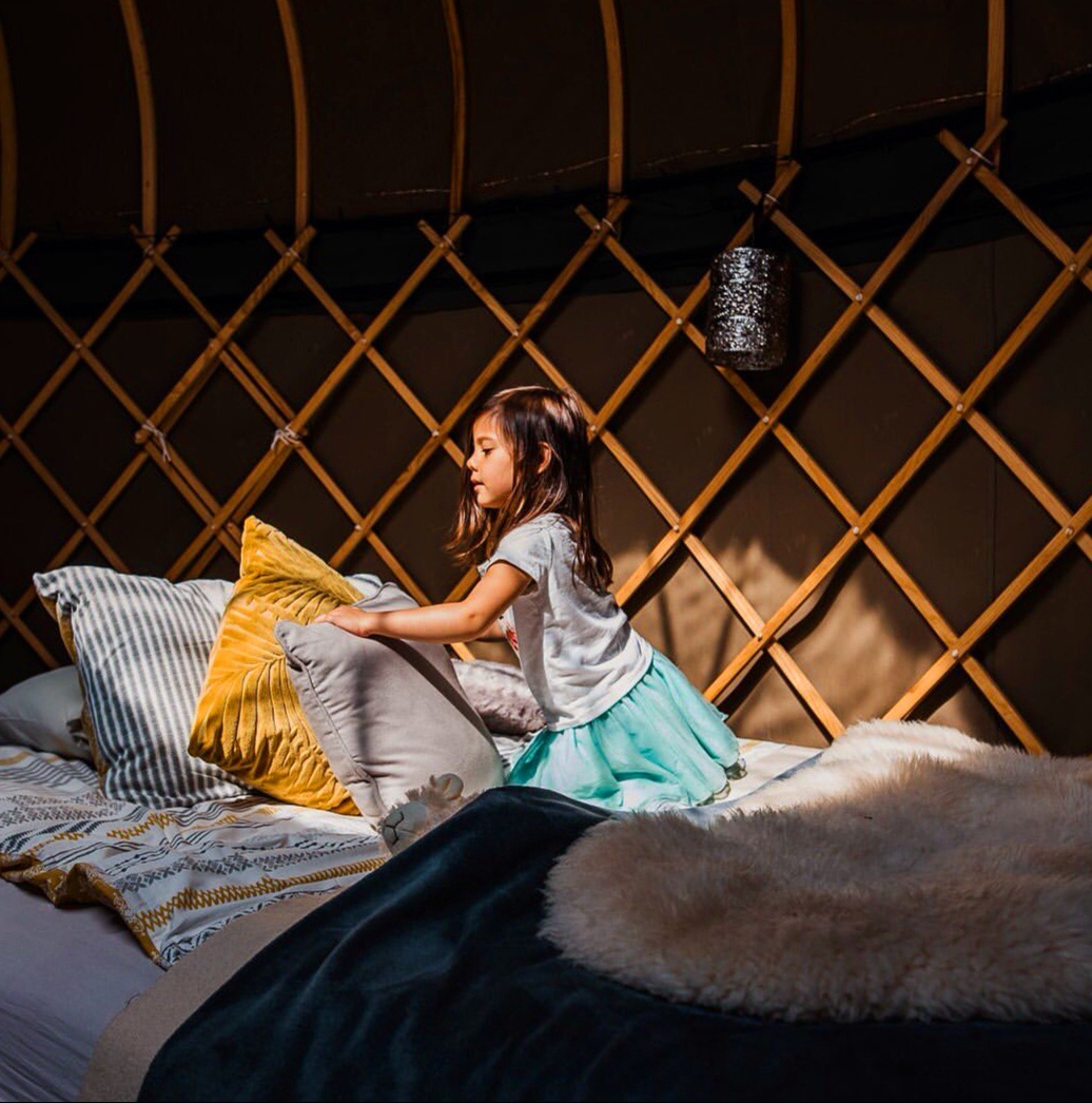 Family friendly glamping Accommodation in Campden Yurts Young girl in a yurt bed