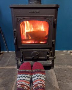 Warming feet in front of a woodburner