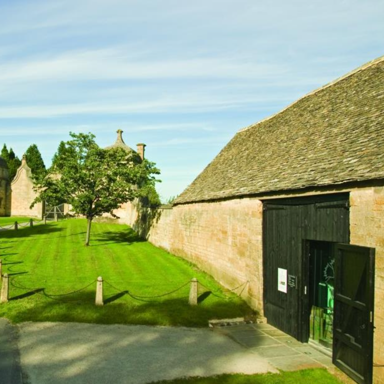 Outside view of Cotswold stone barn housing museum.