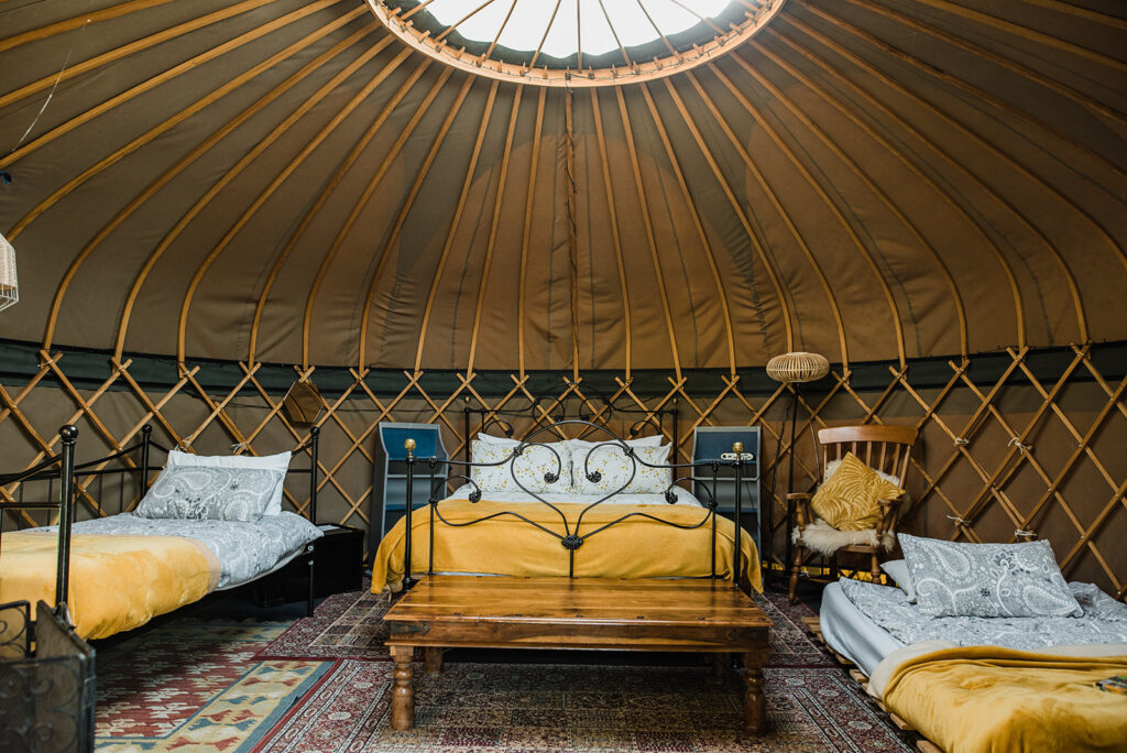 Glamping in Gloucestershire: What is provided inside a glamping yurt including beds, chair, table and lights