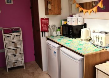 Utility room with fridges, kettle, toaster and microwave