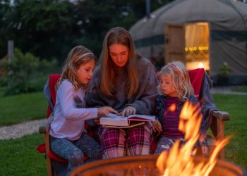 3 children around a campfire having stories